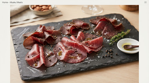 Paper thin sliced cured Halal bresaola and air dried beef charcuterie on vintage butcher slate with cracked peppercorns…